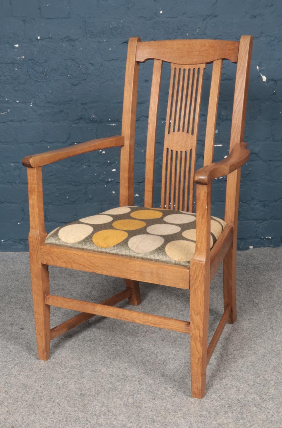 An Art & Crafts style Oak Elbow chair. H: 96cm, W: 58cm.