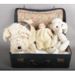 A Navy Blue Suitcase Containing Mostly Linen, along with Soft Toys and Dolls.