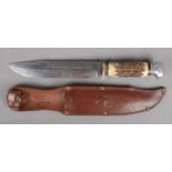 A Jacobs & Co bowie knife with antler handle. In leather sheath.