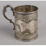 A Victorian Silver Handled Cup with Beaded and Embossed Decoration. Assayed for London, 1874, by