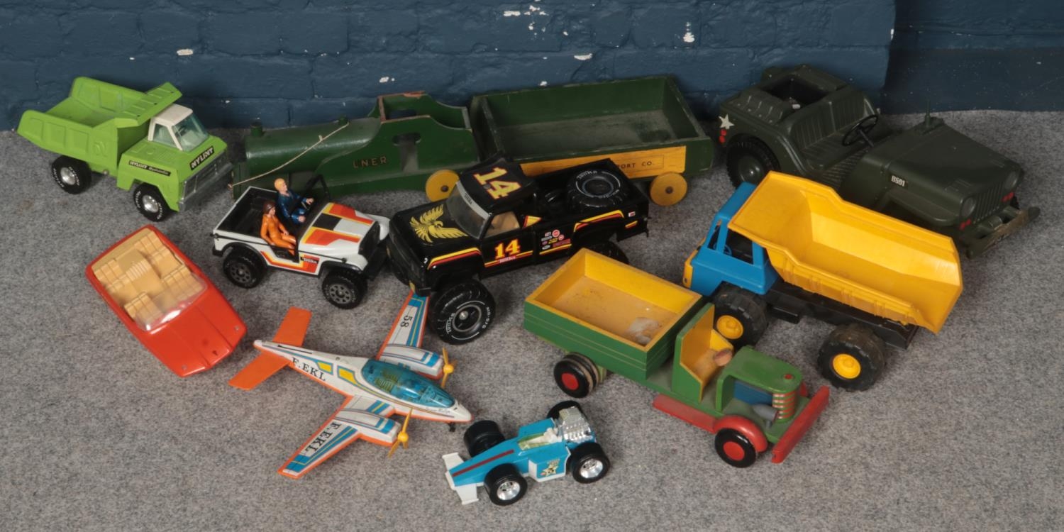 A box of toy vehicles. Including Tonka truck, speedboat, wooden trains, etc.