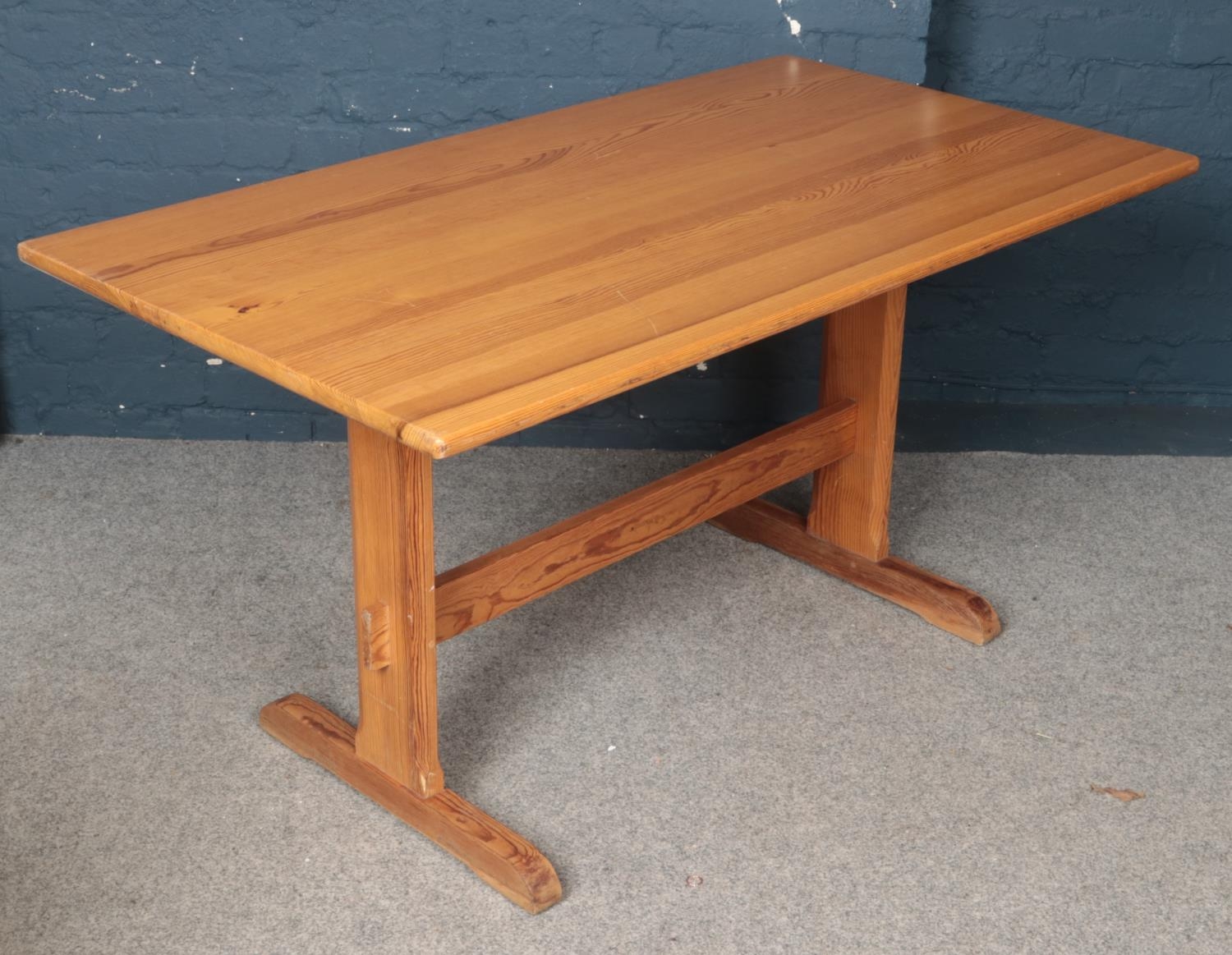 A Ercol pine refectory dining table. (73cm height, 81cm width, 142cm length) comes with pine