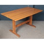 A Ercol pine refectory dining table. (73cm height, 81cm width, 142cm length) comes with pine