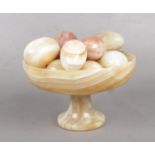 A Marble pedestal stand & eggs.