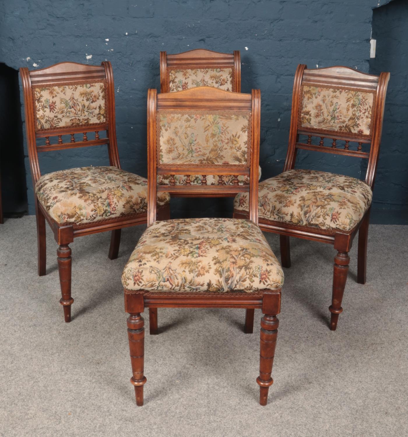 A set of four mahogany dining chairs. With upholstered seats and back rests.