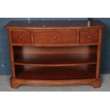 A mahogany bow fronted side cabinet with three drawers. (79cm x 120cm)