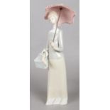 A Lladro Figure of a Woman Holding an Umbrella. Height: 36cm.