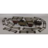 A quantity of clockwork railway. Including Locomotive, carriages, track, etc.