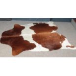 A large Brown & White Cowhide rug. (201cm x174cm)