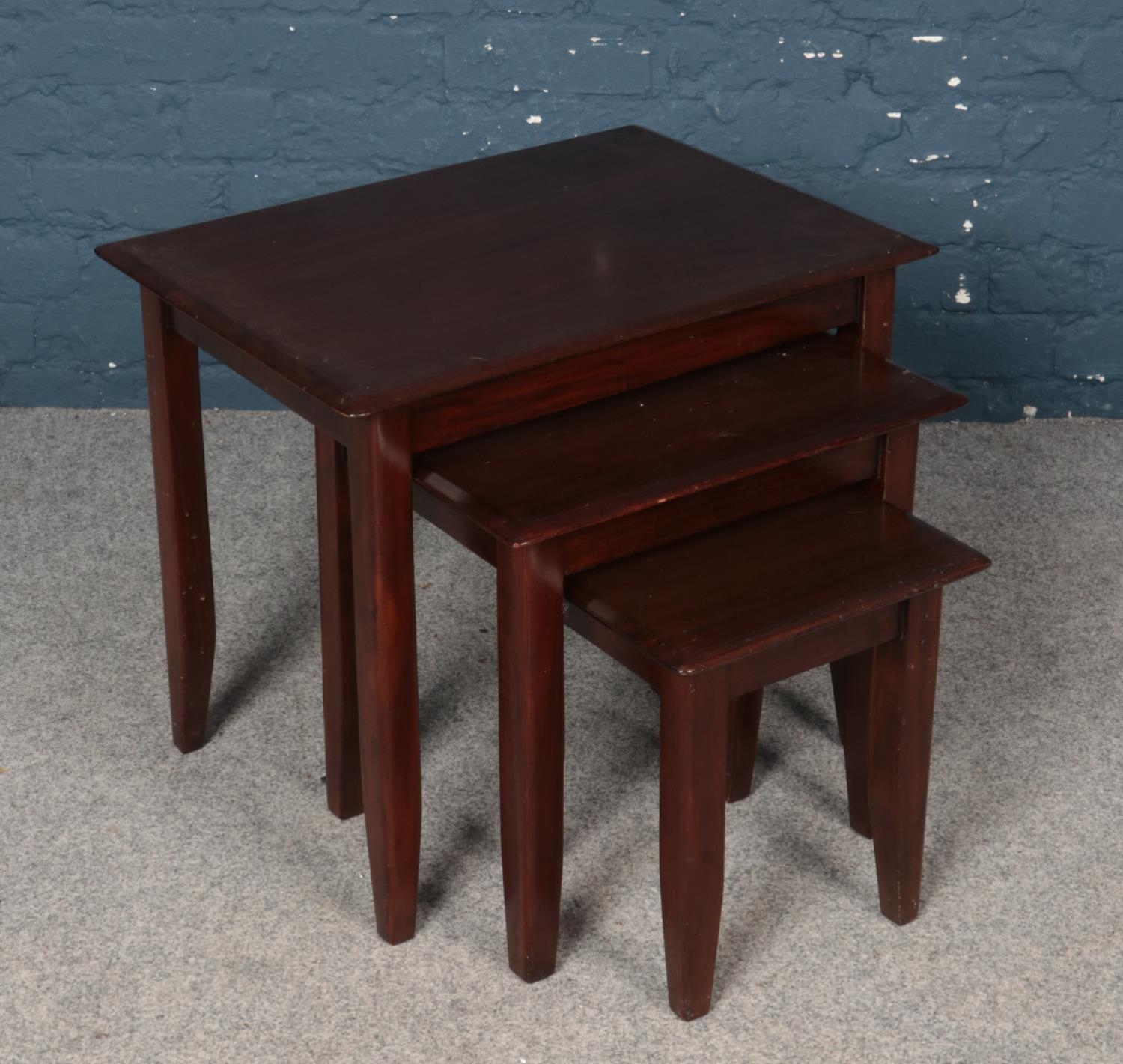 A Nest of Three Mahogany Tables.