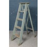 A set of painted wooden step ladders.