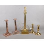 A classical designed brass column lamp base, together with two sets of copper and brass