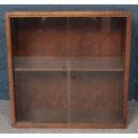 A small oak bookcase with glass sliding doors. (69cm x 69cm)