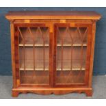 A Yew-Wood Glazed Two Door Bookcase.