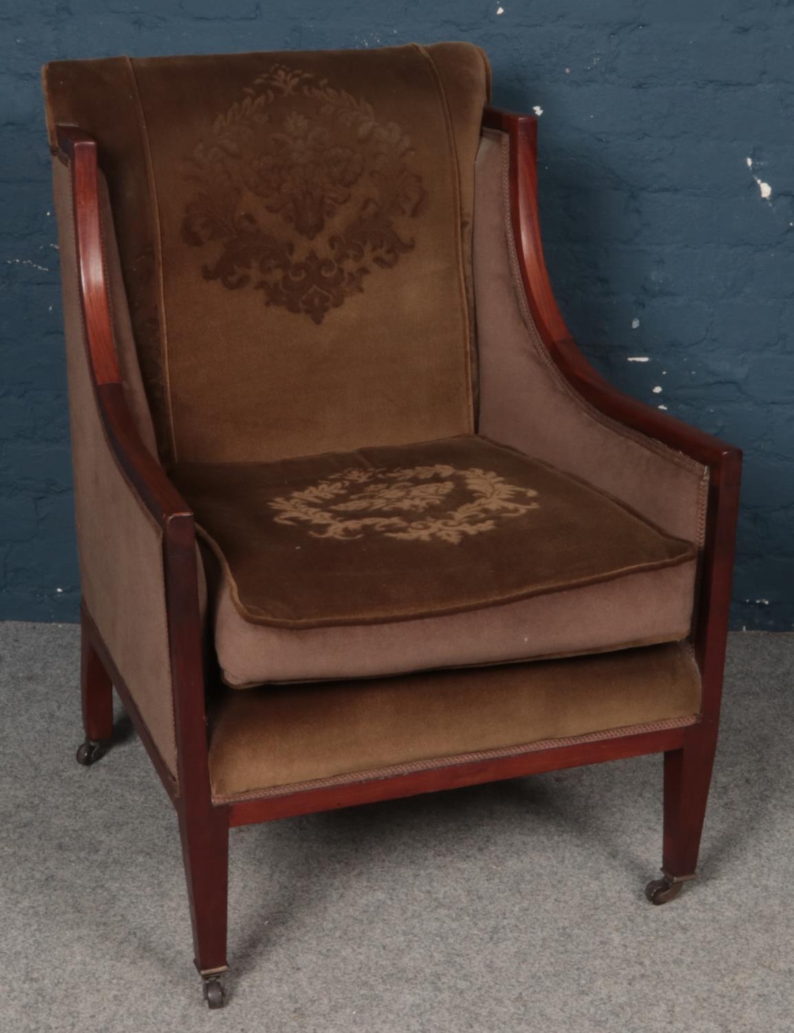 A Mahogany Winged Easy Chair with Fabric Seat and Back.