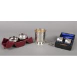 Two boxed sets of Silver napkin rings, together with a a small engraved cup. Comprising of 2 rings