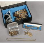 A jewellery box with contents of costume jewellery. Includes yellow metal locket on chain, 18ct gold