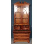 A Yewwood Veneered Bureau Bookcase, with Four Graduated Drawers, produced by Bradley.