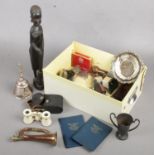 A box of collectables. Includes carved African figure, USSR opera glasses, coins etc.