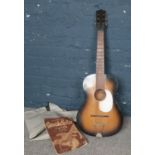 A acoustic guitar with carry case & Spanish guitar tutor book.