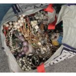 A large bag of costume jewellery. Including beads, bangles, brooches, necklaces, etc.