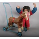 A vintage chimpanzee soft toy along with a vintage push along horse.