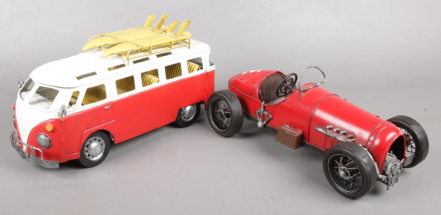 Two vintage style model vehicles. Camper van and a sports car.