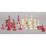 A group of vintage bone chess pieces.