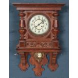 An early 20th century carved oak cased drop dial wall clock.