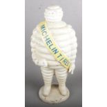 A Cast Iron Michelin Man with Michelin Tires Sash across the Shoulder (56cm Tall).