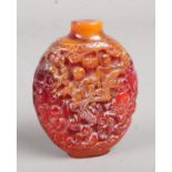 An oriental carved amber scent bottle. Missing stopper.