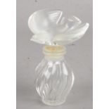 A Lalique scent bottle with Dove stopper. Signed to base. Tiny nibble to one wing.