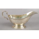 A George V silver sauceboat. Assayed London 1910 by S W Smith & Co. 172g.