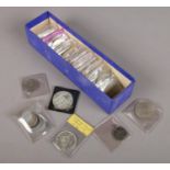 A collection of British and world coins. Includes 1963 Canada dollar, commemorative crowns, Israel