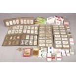 A large quantity of cigarette cards. To include eight albums and twenty five packs of loose cards.