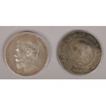 An 1821 Spanish 10 reales coin along with a Silver 1898 Russian 1 Ruple coin.