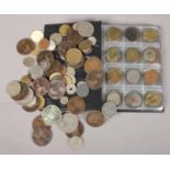 An album and collection of loose coins and tokens.