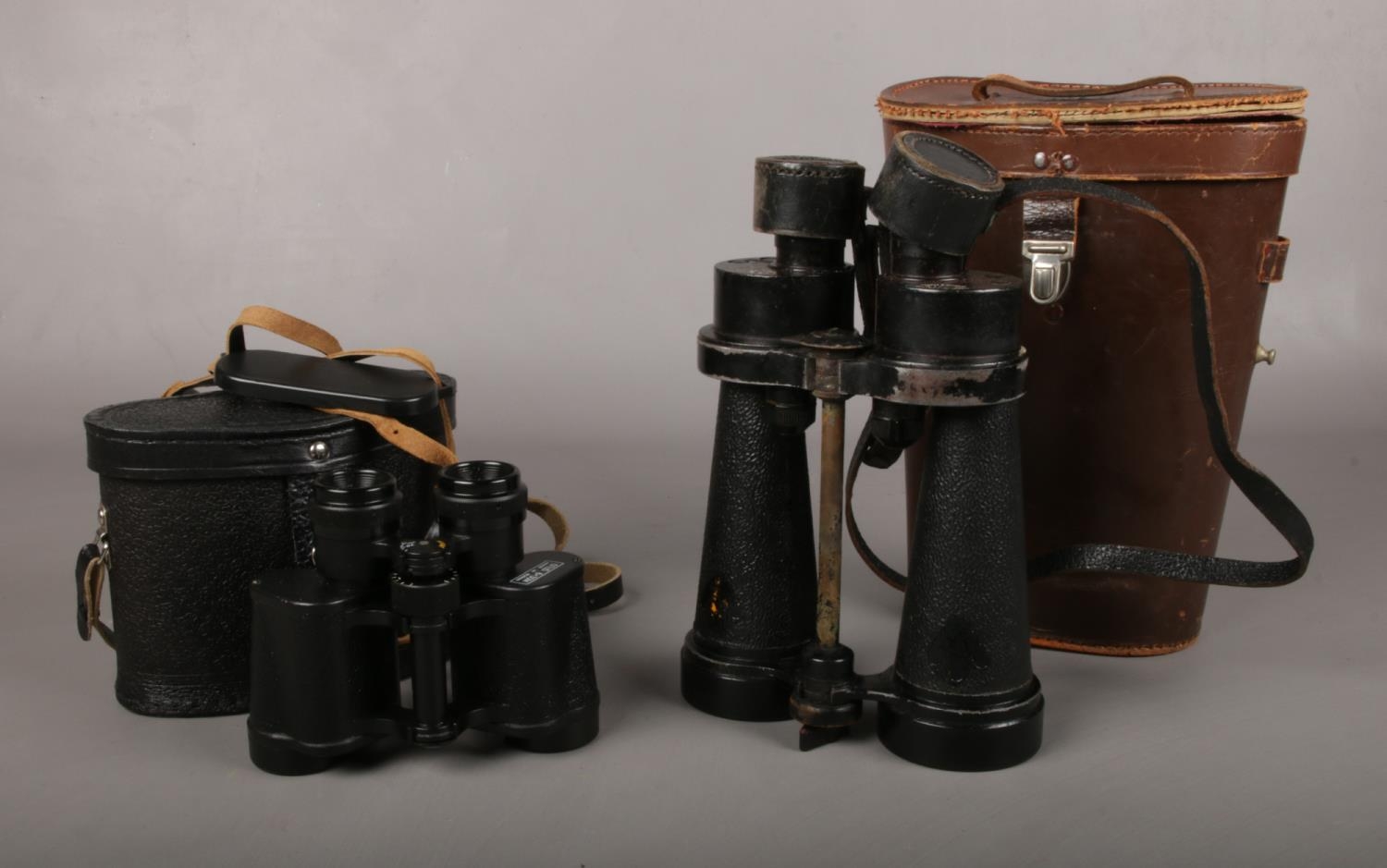 Two cased pairs of binoculars. To include a WW2 pair of Barr & Stroud Royal Navy Binoculars no 85216