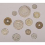 A quantity of mostly oriental white metal coins and tokens. Including 50 Sen coin, etc.