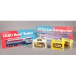 A collection of die cast vehicles. The Esso Road Tanker (boxed), Esso Car Transporter (boxed), Two