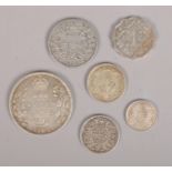 Six Indian silver coins. Including 1840 half Rupee, 1903 one Rupee, 1917 two Annas, etc.