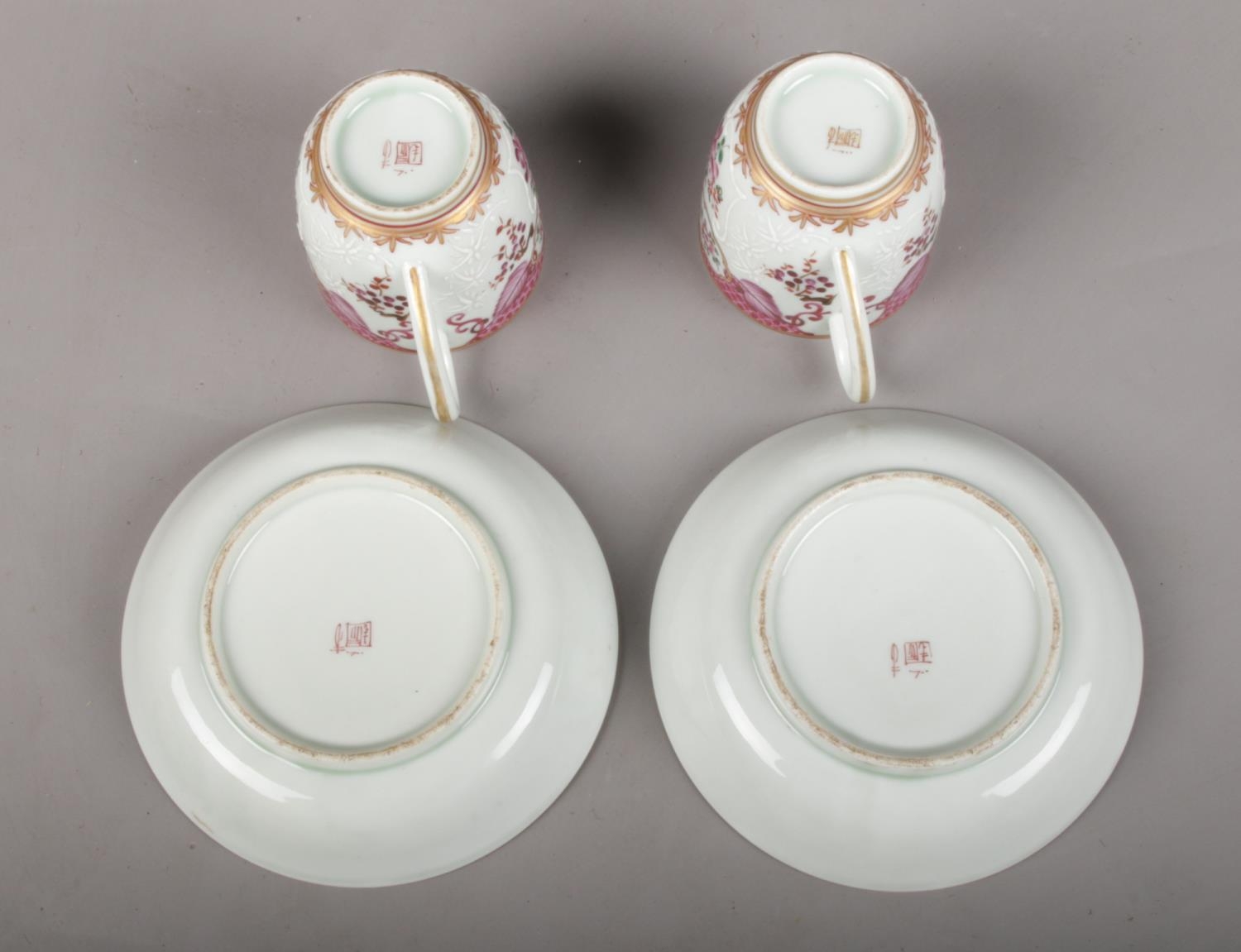 A matching pair of hand-painted 19th century Samson porcelain cups and saucers. Painted in the - Image 2 of 2