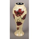 A Moorcroft Baluster Vase depicting Deep Red Anemones. 21cm High. Markings to the Base.