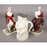 A pair of 19th century Staffordshire figures, along with a Toby jug.