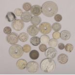 A quantity of mostly silver coins. Including dimes, Serbian coin, French examples, etc.