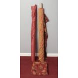 Two rolls of fabric. Comprising of one natural plain muslin and another with a floral pattern.