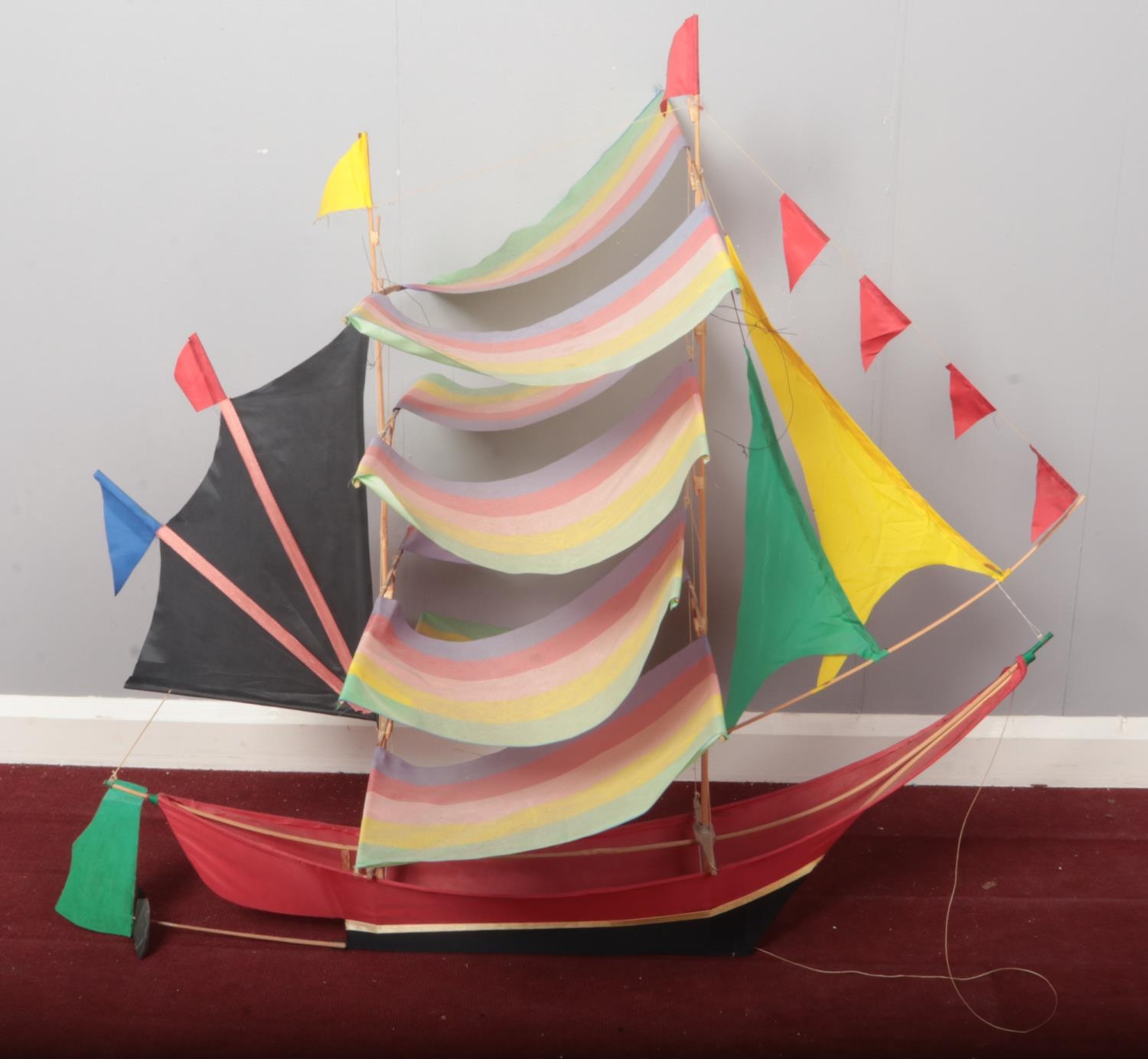 A kite formed as a sail boat. (100cm height 107cm width)