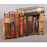 A Carved Wooden Bookstand complete with Fourteen Novels, including the Pickwick Papers and a