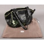 A Radley London black leather handbag with clover decoration. With dust bag.