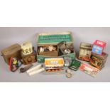 Two boxes of collectables. To include two gas masks, an assortment of vintage tins, and a vintage